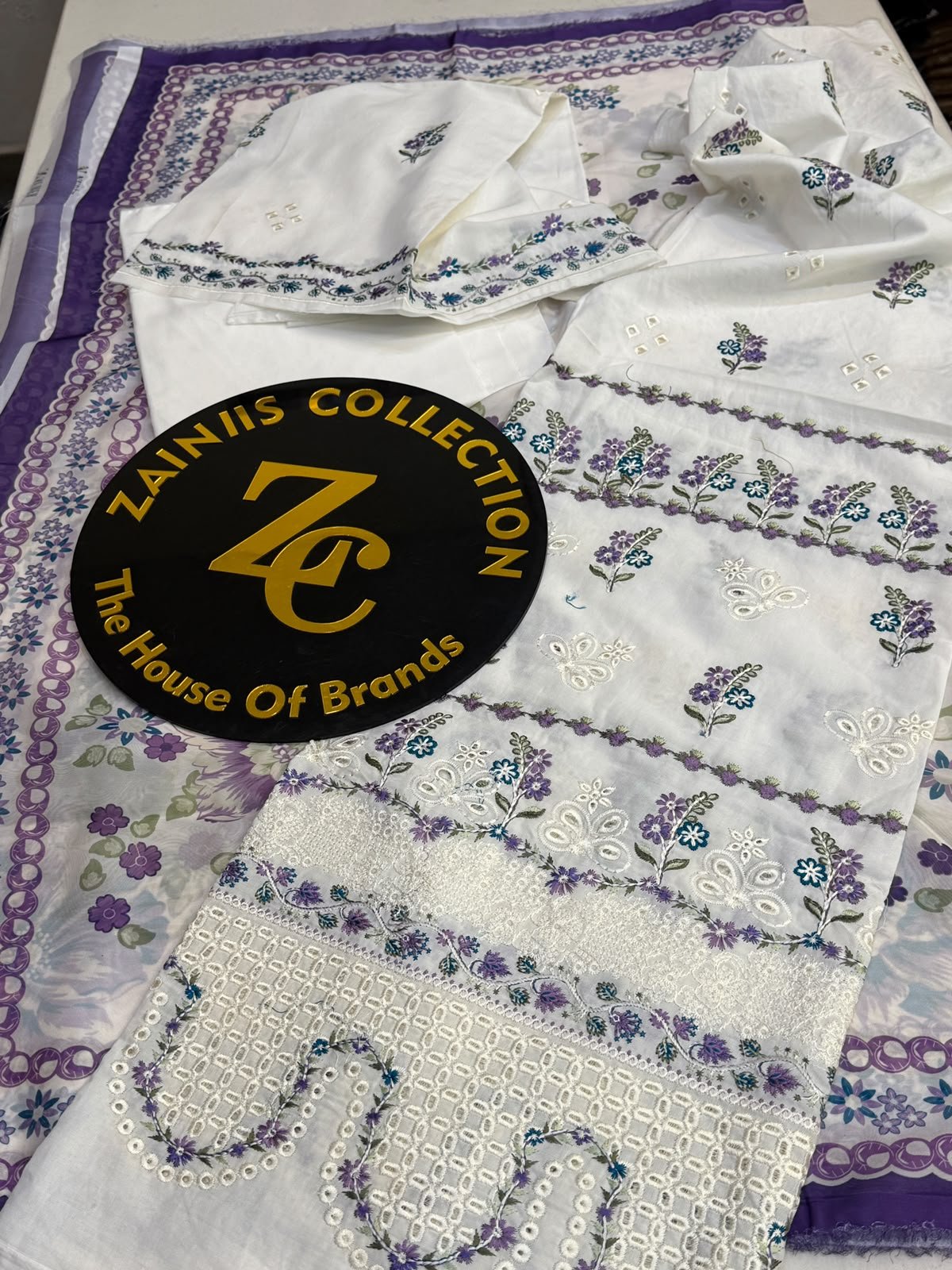 WhatsApp Image 2026-10-06 at 4.24.25 PM (1) Nureh White Embroidered Lawn 3-Piece Suit with Purple Floral Printed Chiffon Dupatta - Image 1