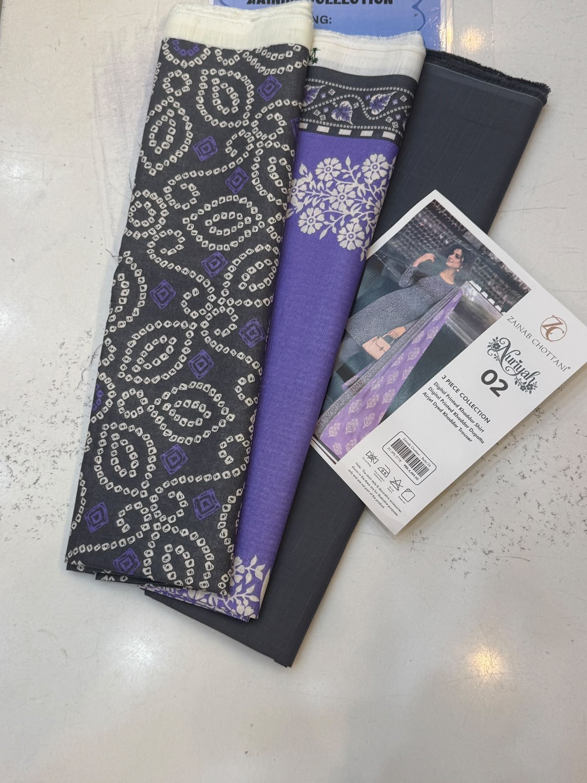 WhatsApp Image 2026-10-14 at 2.27.39 PM Zainab Chottani Nuriyah Collection 02 – Black & Purple Printed Khaddar 3-Piece Suit - Image 1